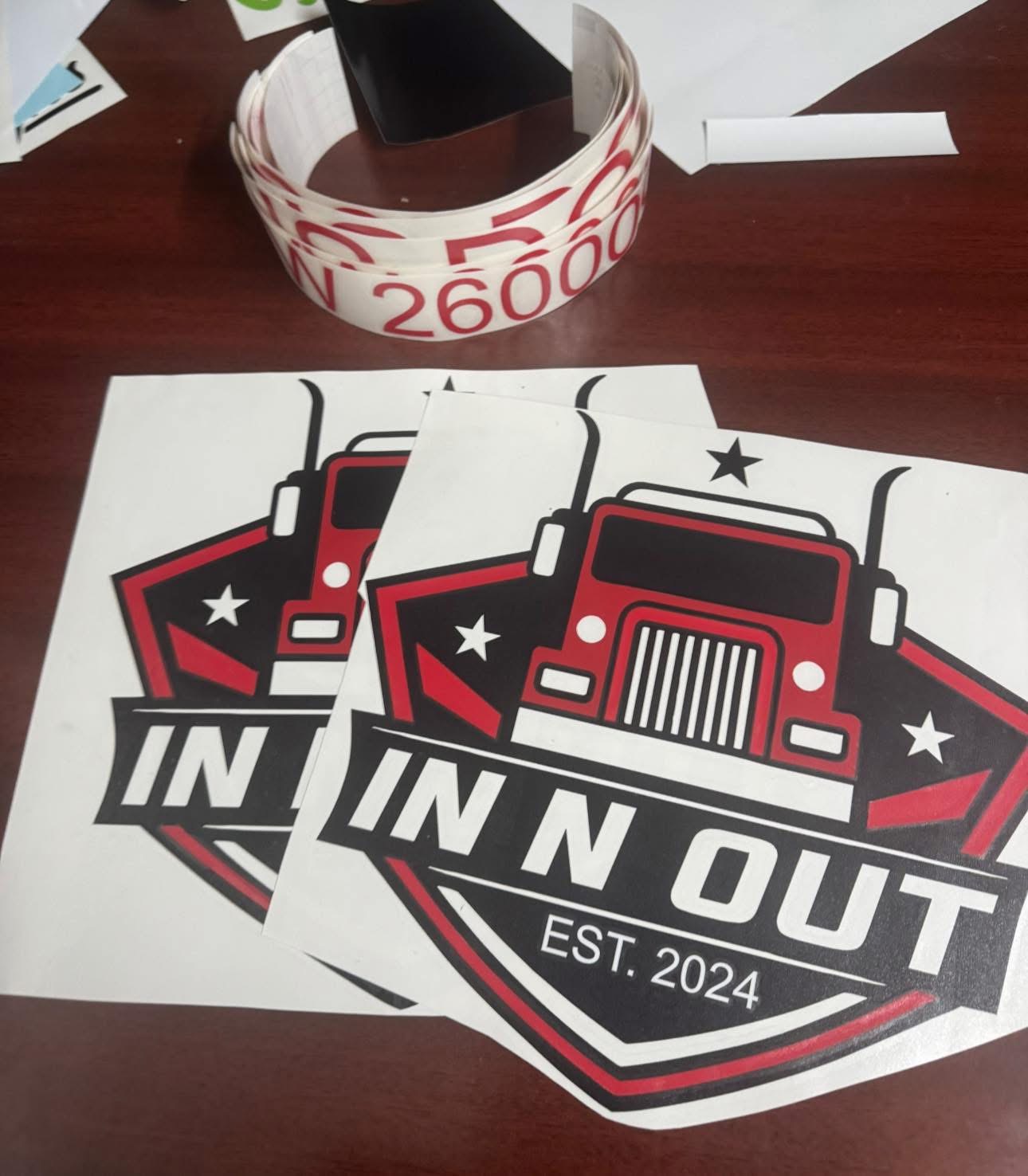 Printed In N Out decals on a work table